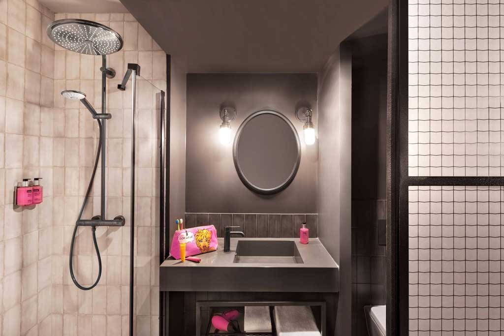 An en suite bathroom has a shower with a massive rainfall shower head. (Photo: Marriott)