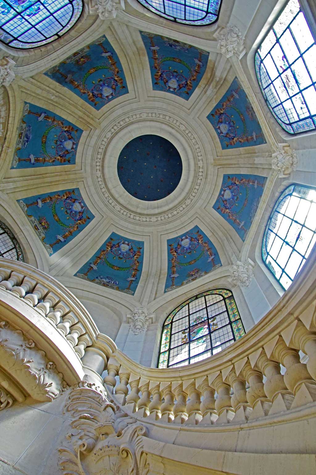 A staircase and blue ceiling at the Palais des Beaux-Arts. (Photo by Martti Salmi on Unsplash)